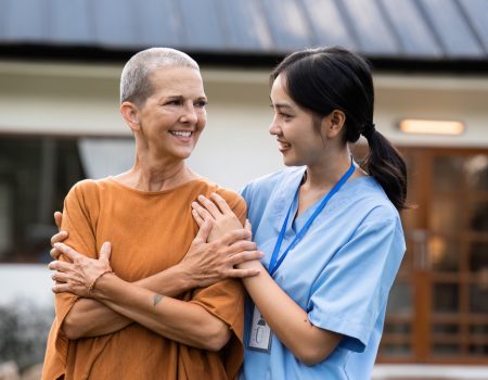 elderly touch hand on back of hand caregiver or nurses to express thankful.